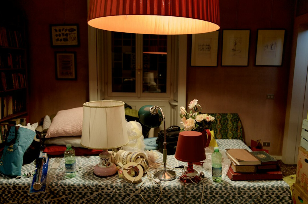 Open books and a reading lamp on a table