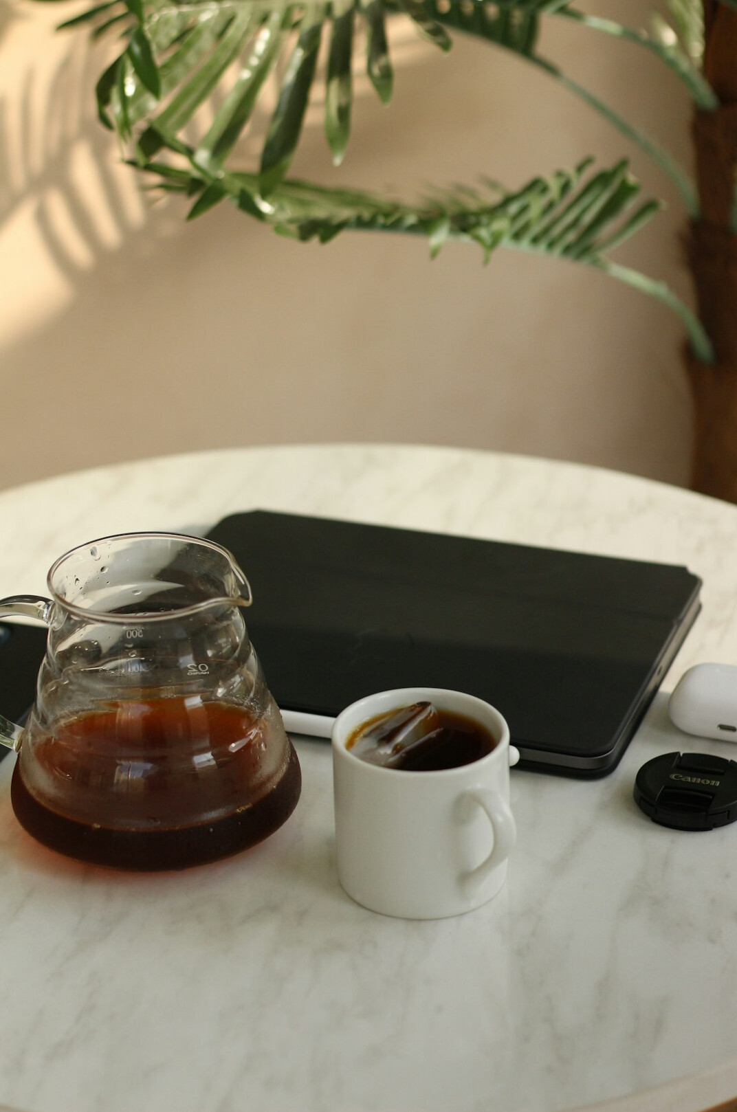 Reading on a laptop at a desk with a cup of coffee