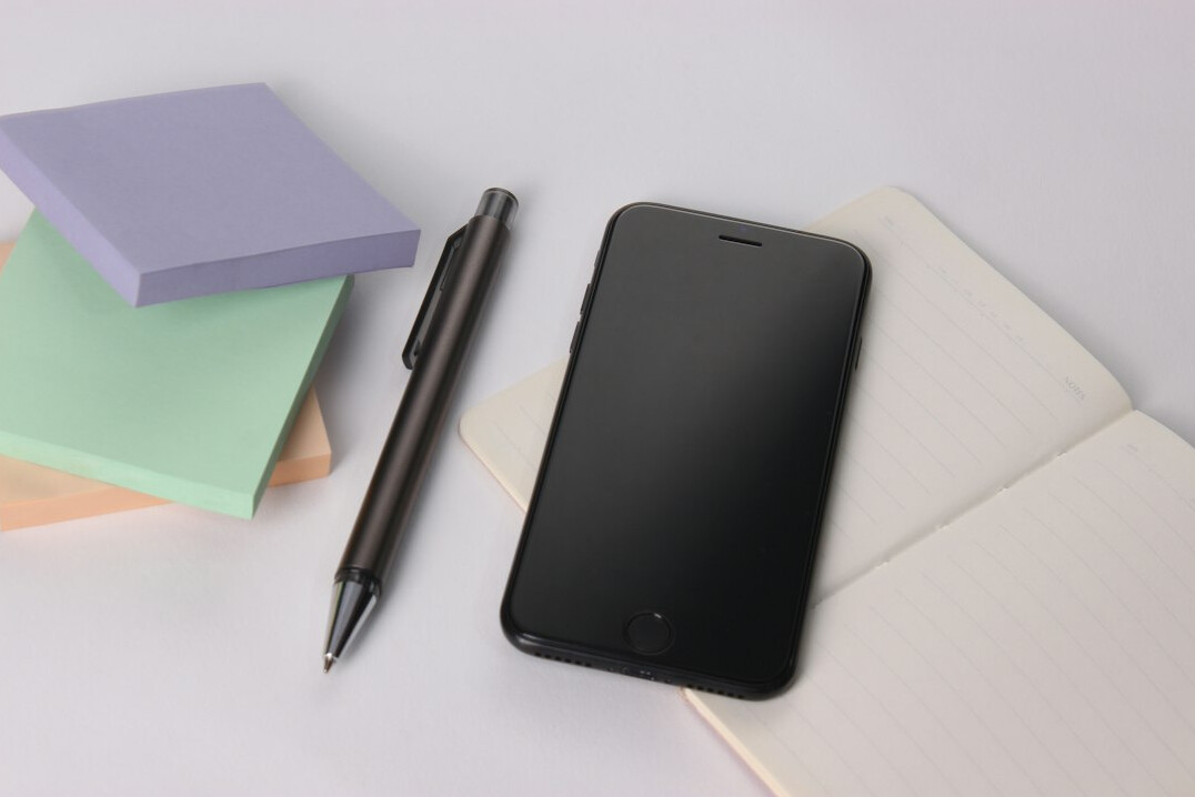 Notebook and pen on a desk ready for writing a letter